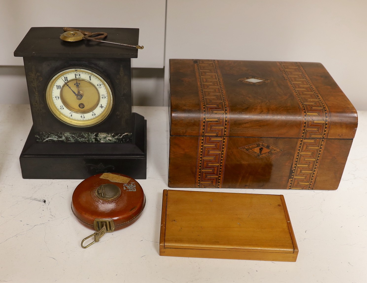A Victorian black slate mantel clock, a parquetry writing box, a surveyor's measure, a cased French painter's set and various locks and keys